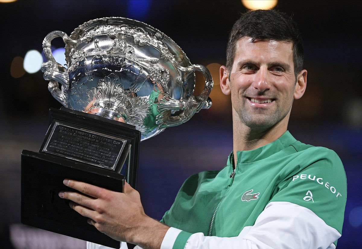 Serbia's Novak Djokovic holds the Norman Brookes Challenge Cup after defeating Russia's Daniil Medvedev in the men's singles final at the Australian Open tennis championship in Melbourn ...