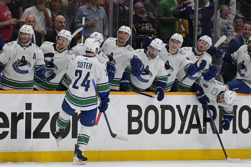 Vancouver Canucks center Pius Suter (24) celebrates his goal against the Nashville Predators with teammates during the third period in Game 6 of an NHL hockey Stanley Cup first-round playoff series Fr ...