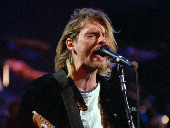 FILE - This Dec. 13, 1993 file photo shows Kurt Cobain of the Seattle band Nirvana performing in Seattle, Wash. Two decades after Nirvana frontman Kurt Cobain killed himself in Seattle, fans flocked t ...