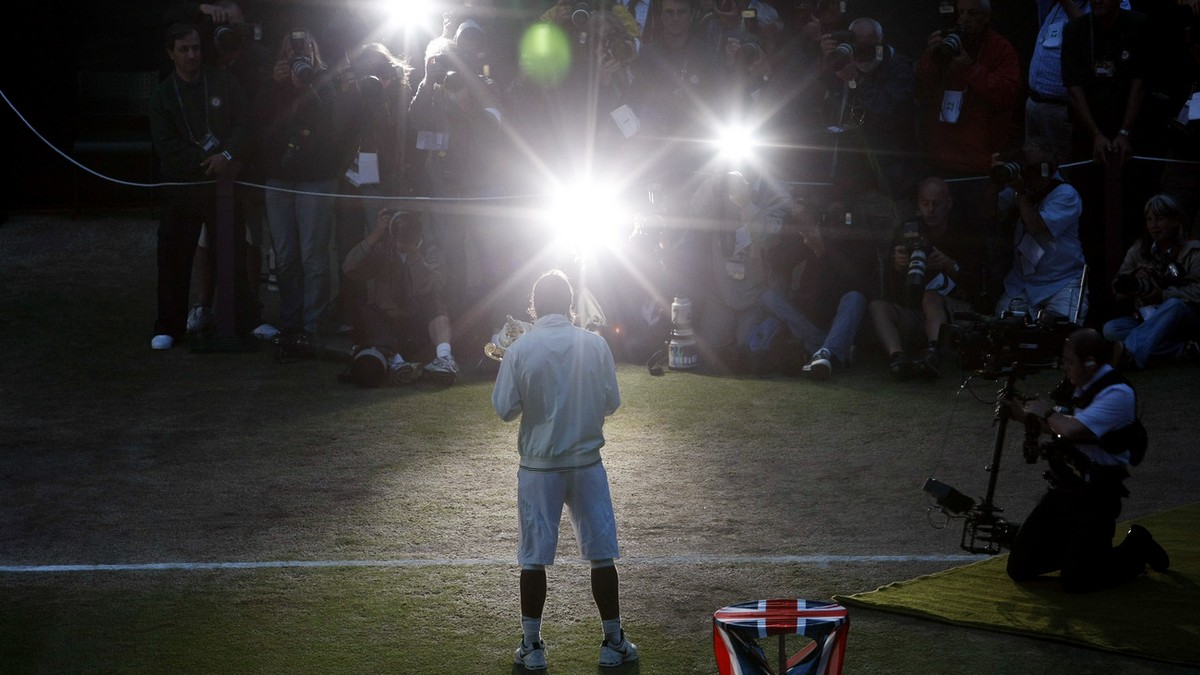 Spain's Rafael Nadal poses for photographers with his trophy after his win over Switzerland's Roger Federer in the men's singles final on the Centre Court at Wimbledon, Sunday, July 6,  ...