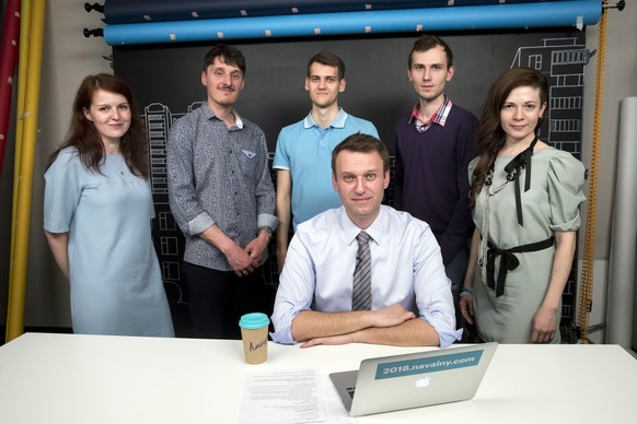 FILE - Russian opposition leader Alexei Navalny, center, and his team, stand from left: Navalny&#039;s spokeswoman Kira Yarmysh, live broadcast director Alexei Yakovlev, live broadcast director Artem  ...