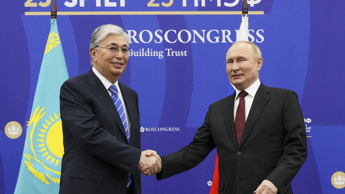 Russian President Vladimir Putin, right, and Kazakhstan's President Kassym-Jomart Tokayev shake hands prior to their talks on the sidelines of the St. Petersburg International Economic Forum in S ...