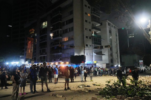 People stand outside damaged buildings after an earthquake in Caracas, Venezuela, Wednesday, June 24, 2026. (AP Photo/Adrian Naranjo)
Venezuela Earthquake