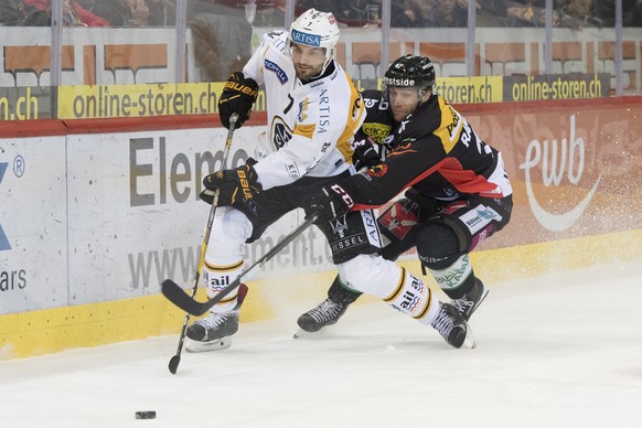 LuganoÕs Philippe Furrer, links, und Berns Gian-Andrea Randegger, rechts, kaempfen um den Puck, beim Eishockey Meisterschaftsspiel der National League zwischen den SC Bern und dem HC Lugano, am Samsta ...