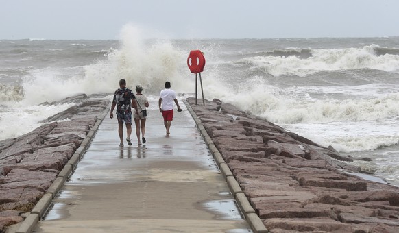 People watch waves crash into the 37th Street rock groin in Galveston, Texas on Sunday, July 7, 2024, as Tropical Storm Beryl churns toward the Texas Coast. (Jennifer Reynolds/The Galveston County Dai ...