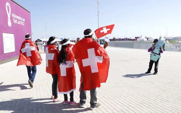 epa10324168 Supporters of Switzerland have a picture taken as they arrive to the stadium for the FIFA World Cup 2022 group G soccer match between Switzerland and Cameroon at Al Janoub Stadium in Al Wa ...
