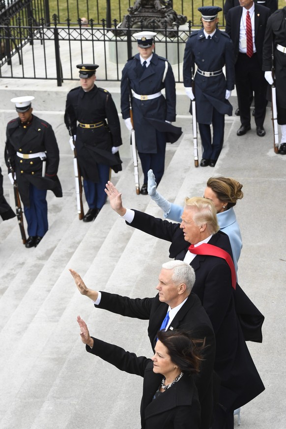 epa05735785 US President Donald Trump (2-R), First Lady Melania Trump (R), Vice President Mike Pence (2-L), and Karen Pence (L) wave as former President Barack Obama and Michelle Obama depart during t ...