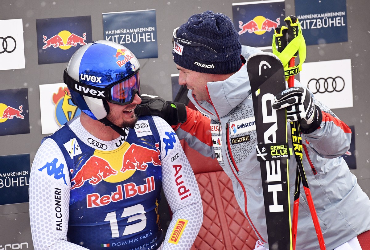 epa07317962 Dominik Paris (L) of Italy and Beat Feuz (R) of Switzerland react in the finish area during the Men's Downhill race of the FIS Alpine Skiing World Cup in Kitzbuehel, Austria, 25 Janua ...
