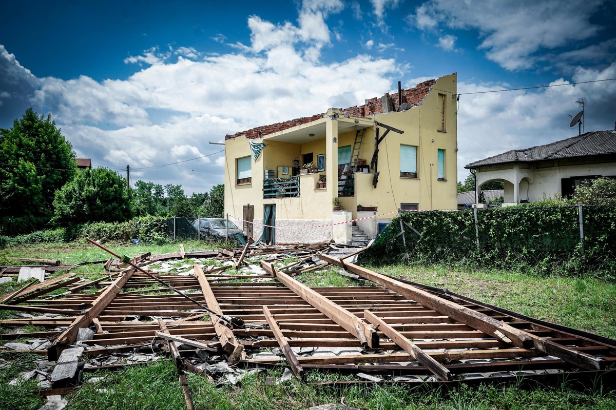 epa11447105 A building with its roof damaged by a whirlwind in Busano Canavese, near Turin, Italy, 30 June 2024. Storms hit the Alpine valleys of Turin, in particular the Orco Valley, on 29 June, caus ...
