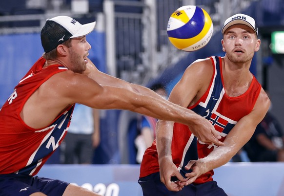 epa09398224 Anders Berntsen Mol of Norway (L) and teammate Christian Sandlie Sorum in action during the semi final between Norway and Latvia during the Beach Volleyball events of the Tokyo 2020 Olympi ...