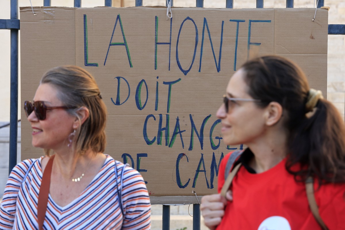 epa11669103 Participants stand next to a placard that reads 'The shame has to change of side, as Feminist group attend a rally in Montpellier, Southern France, 19 October 2024. The Feminist group ...