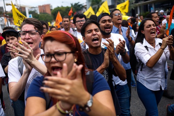 epa06742507 Opposition demonstrators participate in a march to the headquarters of the Organization of American States (OAS), against the presidential elections of May 20, in Caracas, Venezuela, 16 Ma ...