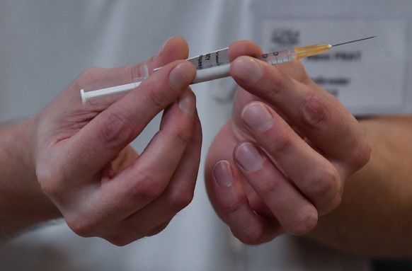 A nurse prepares a dose of the Pfizer-BioNTech Covid-19 vaccine at the at the Champmaillot nursing home in Dijon, central France, Sunday Dec. 27, 2020. France is starting its first vaccinations Sunday ...