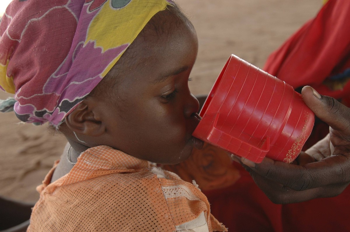 A woman feeds her baby F100, a specially designed milk-based-food for severely malnourished children, in a UNICEF supported Therapeutic Feeding Center run by ACF (Action Contre La Fiam or Action Again ...
