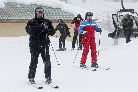 Russian President Vladimir Putin, right, and Belarusian President Alexander Lukashenko arrive at the mountain resort of Krasnaya Polyana near the Black Sea resort of Sochi, Russia, Monday, Feb. 22, 20 ...