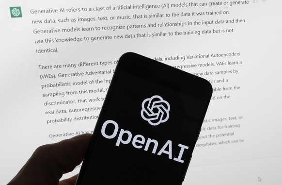 FILE - The OpenAI logo is seen on a mobile phone in front of a computer screen displaying output from ChatGPT, March 21, 2023, in Boston. The head of the artificial intelligence company that makes Cha ...