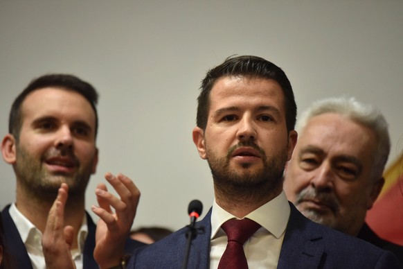 epa10556379 Jakov Milatovic (C), Montenegro&#039;s presidential candidate, addresses the media after the early results of the second round of the presidential elections in Podgorica, Montenegro, 02 Ap ...