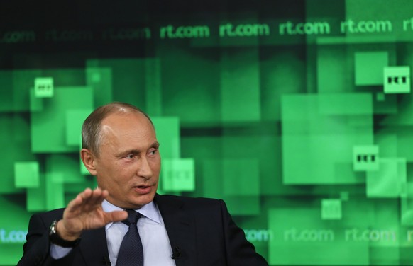 Russian President Vladimir Putin speaks during his visit to the new headquarters of &quot;Russia Today&quot; TV channel in Moscow, Russia, Tuesday, June 11, 2013. (AP Photo/Yuri Kochetkov, Pool)