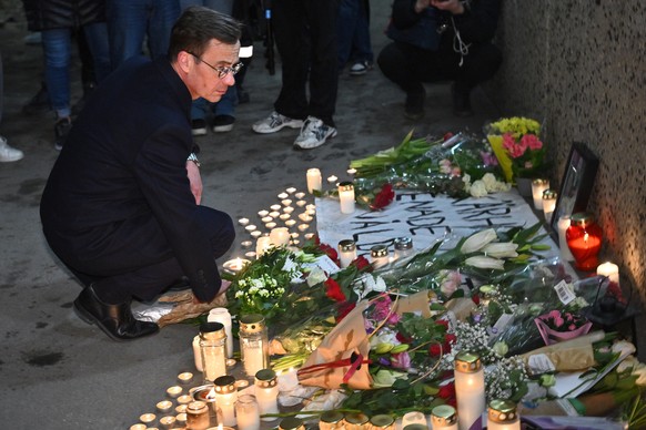epa11273439 Sweden&#039;s Prime Minister Ulf Kristersson visits the memorial site near the center of Skarholmen, southern Stockholm, Sweden, 11 April 2024, where a man was shot dead in an underpass la ...