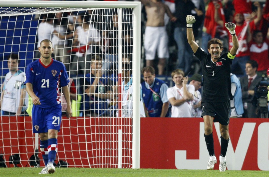 Turkey&#039;s Rustu Recber, right, celebrates after saving a penalty kick by Croatia&#039;s Mladen Petric, left, in the penalty shoot out of the quarterfinal match between Croatia and Turkey in Vienna ...