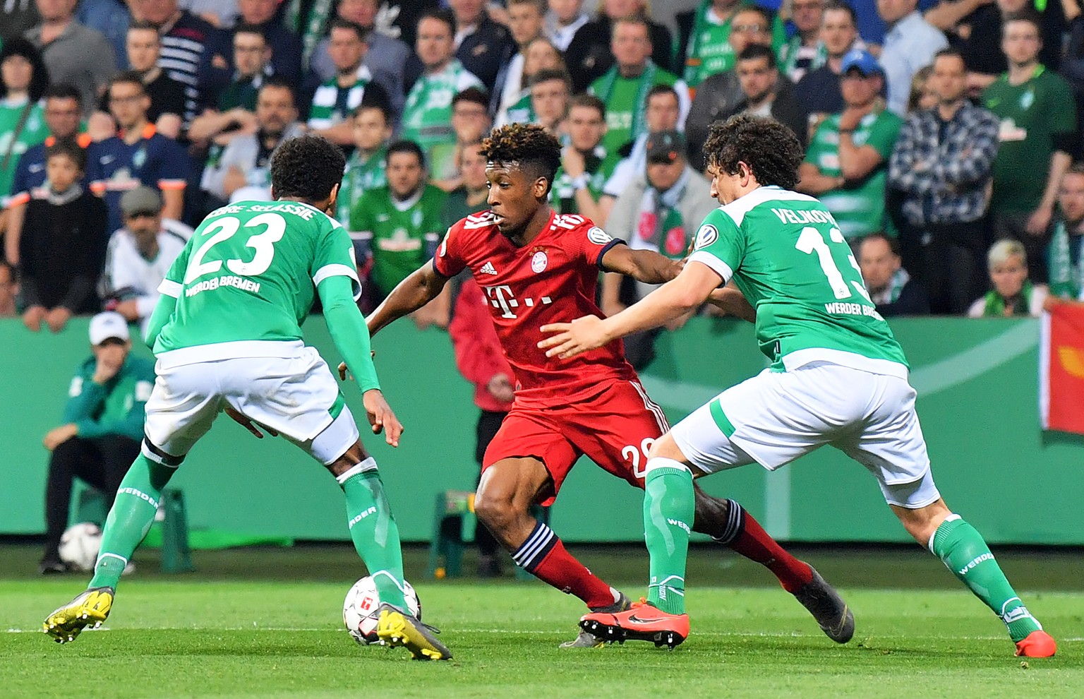 epa07526141 Bayern&#039;s Kingsley Coman (C) in action against Bremen players Theodor Gebre Selassie (L) and Milos Veljkovic (R) during the German DFB Cup semi final soccer match between Werder Bremen ...