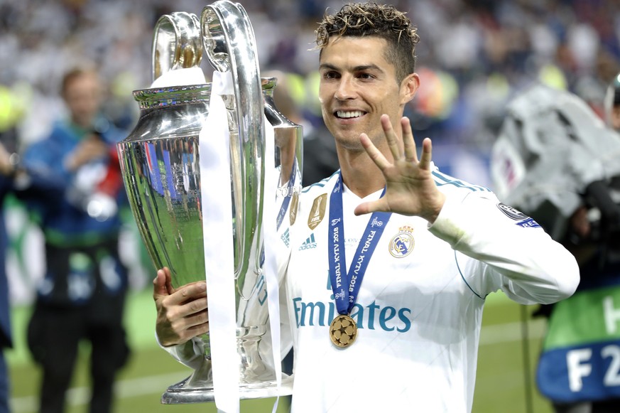 Real Madrid's Cristiano Ronaldo celebrates with the trophy after winning the Champions League Final soccer match between Real Madrid and Liverpool at the Olimpiyskiy Stadium in Kiev, Ukraine, Saturday ...