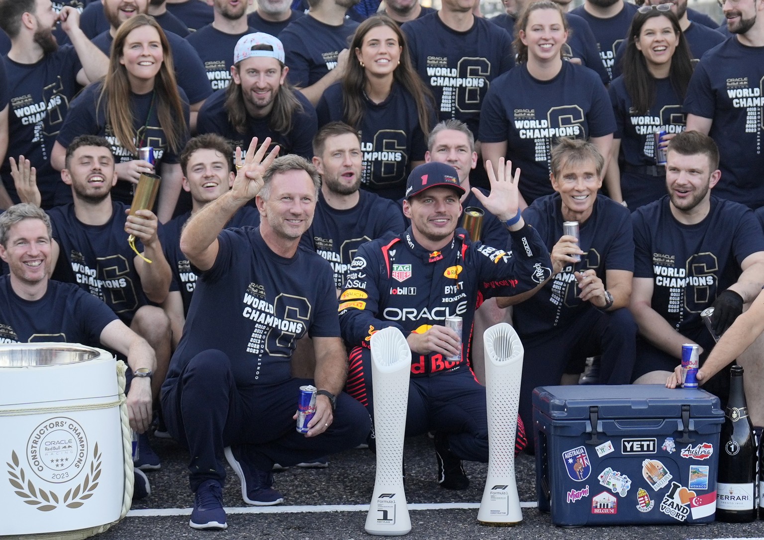 epa10880101 Team chief Christian Horner (C-L) of Red Bull Racing and Dutch Formula One driver Max Verstappen (C-R) of Red Bull Racing celebrate the constructors title after the Formula One Japanese Gr ...