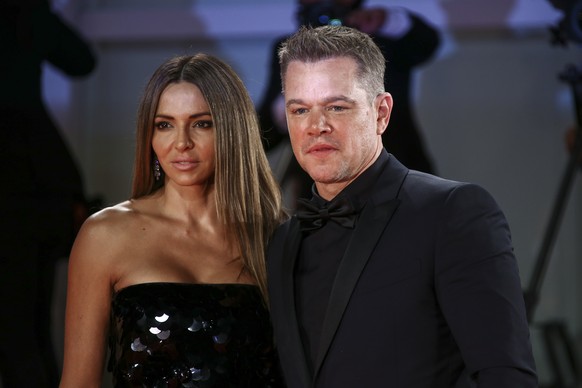 Matt Damon, right, and Luciana Barroso pose for photographers upon arrival at the premiere of the film &#039;The Last Duel&#039; during the 78th edition of the Venice Film Festival in Venice, Italy, F ...