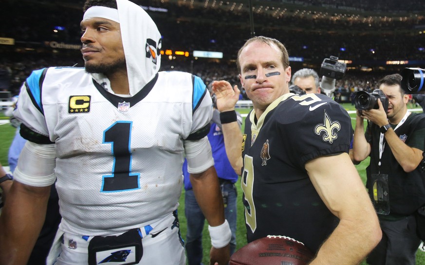 epa06423891 Carolina Panthers quarterback Cam Newton (L) and New Orleans Saints quarterback Drew Brees after the New Orleans Saints&#039; win in the NFL American football NFC wild card playoff game ag ...