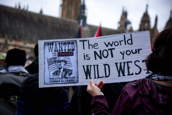September 17, 2025, London, England, United Kingdom: A protestor holds a placard during the Trump not welcome demonstration at Parliament Square. Around 50 protest groups were expected to gather toget ...