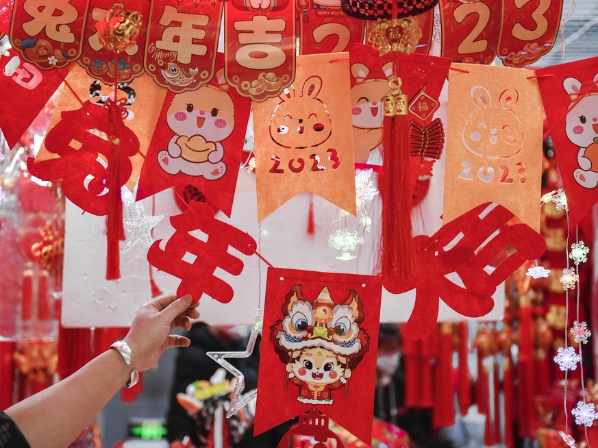 epa10417700 People select decorations for the Spring Festival in Changchun, Jilin Province, China, 19 January 2023 (issued 20 January 2023). This year's Spring Festival, or the Chinese New Year, ...