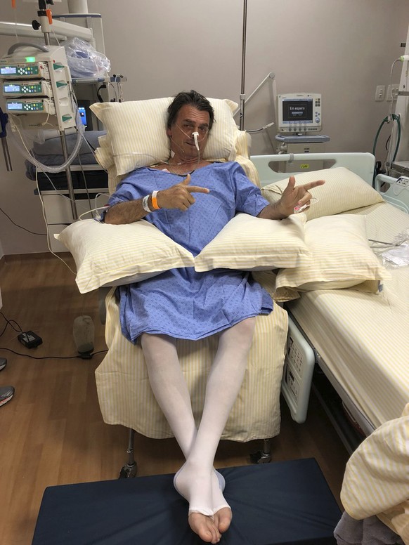 In this Sept. 8, 2018 handout photo provided by the National Social Liberal Party press office, presidential candidate Jair Bolsonaro poses for a photo while sitting in his hospital room at the Albert ...