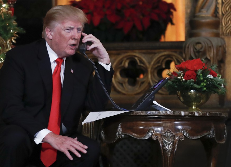 President Donald Trump speaks on the phone with children as they track Santa Claus&#039; movements with the North American Aerospace Defense Command (NORAD) Santa Tracker on Christmas Eve at the presi ...