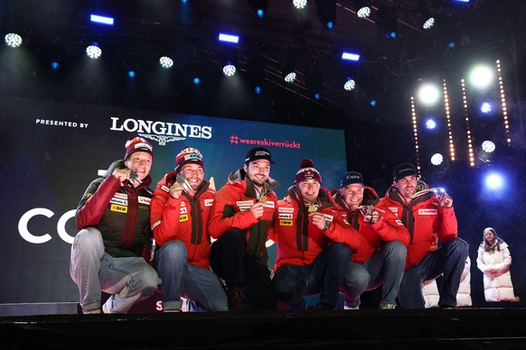 epa11891378 Silver medalists Tanguy Nef and Alexis Monney of Switzerland, gold medalists Loic Meillard and Franjo von Allmen of Switzerland and bronze medalists Stefan Rogentin and Marc Rochat of Swit ...