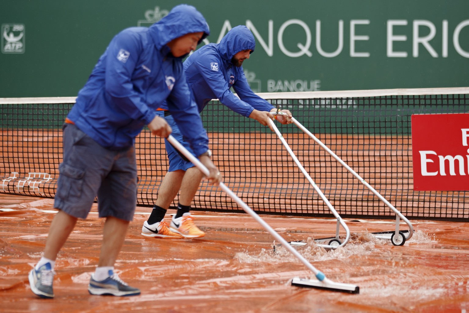 epa06756275 Staff remove water from the rain cover of the central court before the second round match between Stanislas &#039;Stan&#039; Wawrinka of Switzerland and Jared Donaldson of USA at the Genev ...