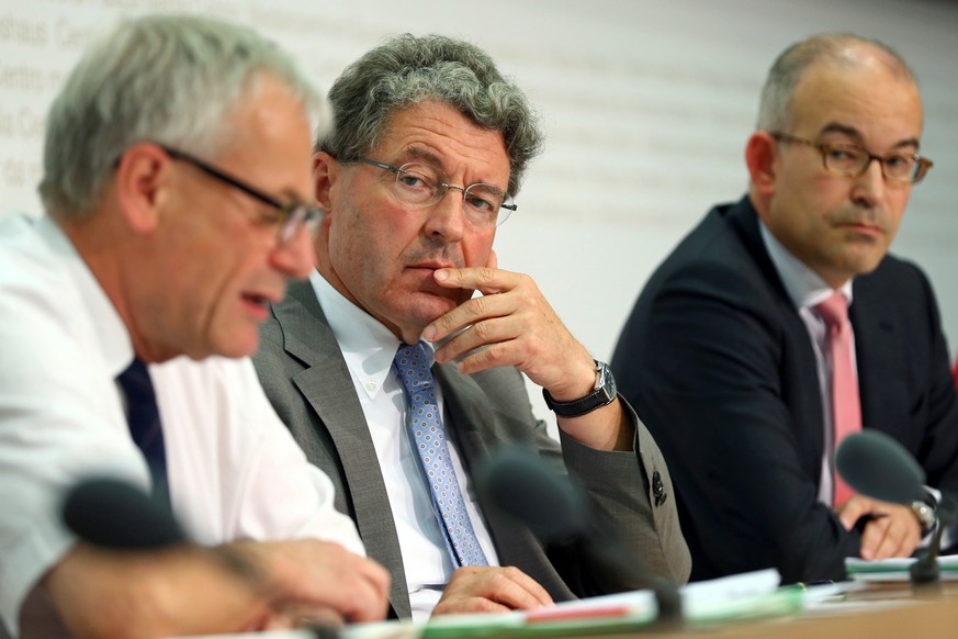 Swiss lower house Political Institutions Committee President Heinz Brand (C) and Committee members Kurt Fluri (L) and Gregor Rutz attend a news conference on the mass immigration initiative in Bern, S ...