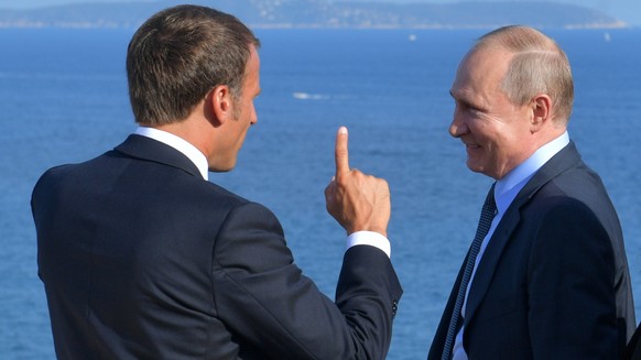 FILE - French President Emmanuel Macron, left, talks with Russian President Vladimir Putin during their meeting at the fort of Bregancon in Bormes-les-Mimosas, southern France, Monday Aug. 19, 2019. ( ...