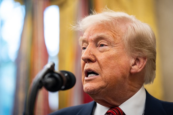 epa12081949 US President Donald Trump answers questions from reporters after former US Senator David Perdue (not pictured) was sworn in as the United States Ambassador to the Peoples Republic of China ...