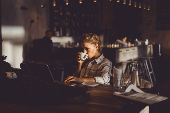 Frau trinkt Kaffee in einer Bar.