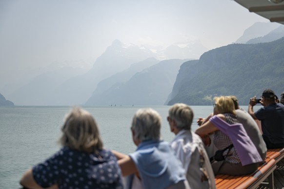 A haze of smoke from Canadian wildfires blankets the sky and mountains at the Urnersee in Brunnen, Switzerland, Wednesday, June 11, 2025. The smoke, originating from wildfires in Manitoba and Saskatch ...