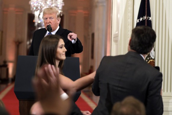 As President Donald Trump points to CNN&#039;s Jim Acosta, a White House aide takes the microphone from him during a news conference in the East Room of the White House, Wednesday, Nov. 7, 2018, in Wa ...