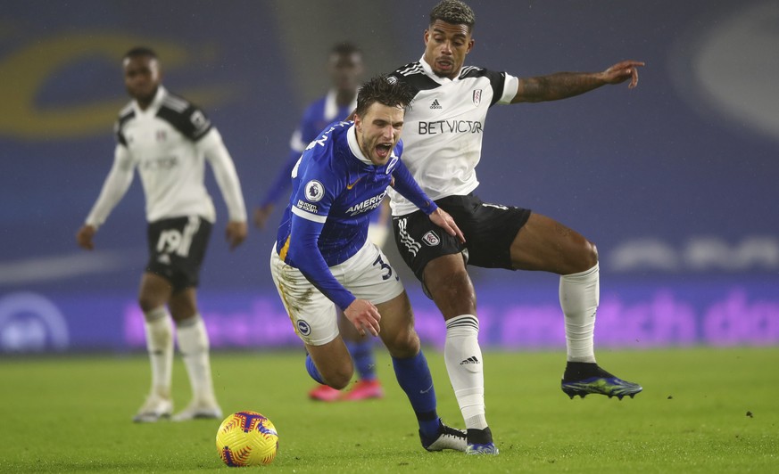 Brighton&#039;s Joel Veltman, centre, falls in front of Fulham&#039;s Mario Lemina during an English Premier League soccer match between Brighton and Fulham at the Amex stadium in Brighton, England, W ...
