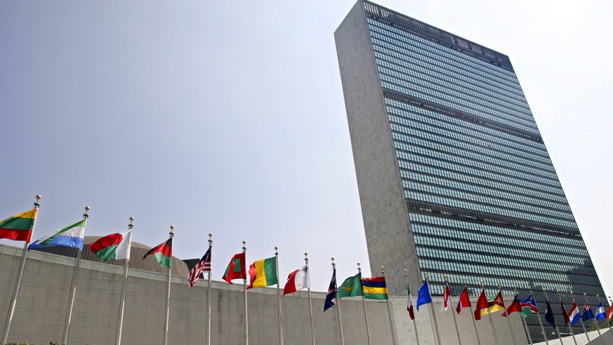 FILE - In this Sept. 13, 2005 file photo, the flags of member nations fly outside the General Assembly building at the United Nations headquarters in New York. The U.N. General Assembly overwhelmingly ...