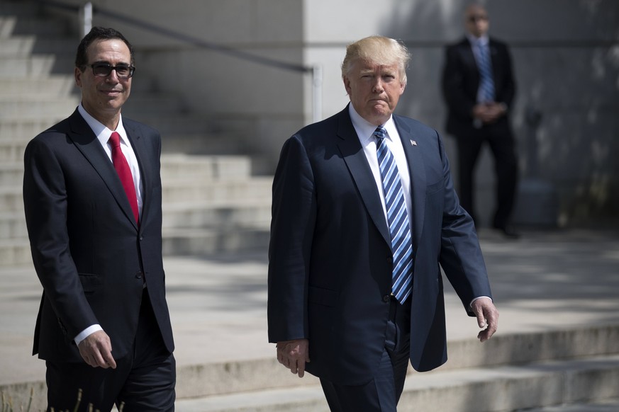 epa05920144 US President Donald J. Trump (R) and Secretary of Treasury Steven Mnuchin (L) walk out of the Treasury Department after a financial services Executive Order signing ceremony in Washington, ...