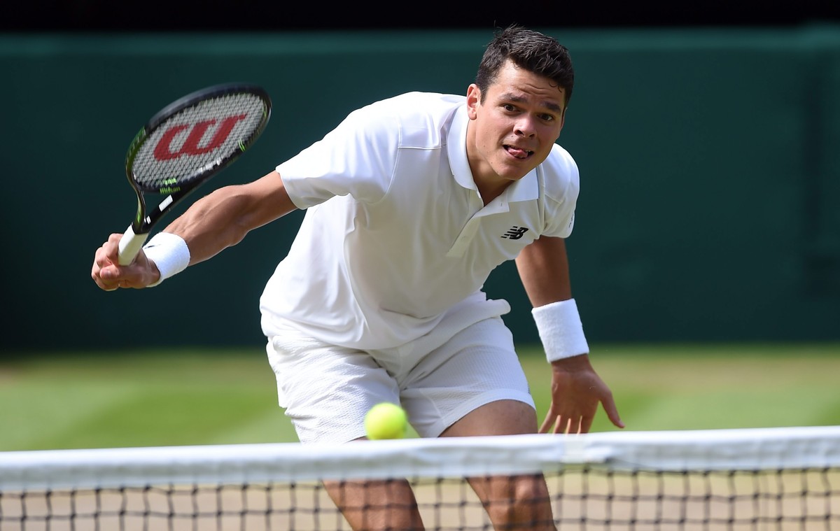 epa05418505 Milos Raonic of Canada returns to Andy Murray of Britain in the men's singles final of the Wimbledon Championships at the All England Lawn Tennis Club, in London, Britain, 10 July 201 ...