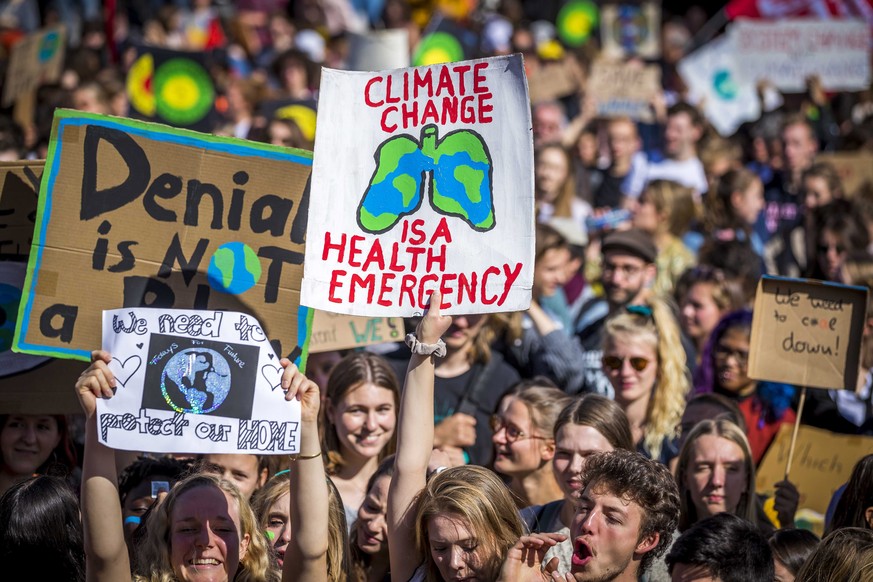 epa07856797 Protesters walk through the center of Maastricht, the Netherlands, during a climate march as a part of the Fridays for Future global climate strike, 20 September 2019. Millions of people a ...
