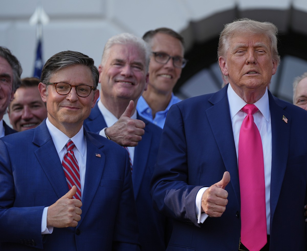 President Donald Trump poses for a photo with first lady Melania Trump, House Speaker Mike Johnson of La., and others, after he signed his signature bill of tax breaks and spending cuts at the White H ...