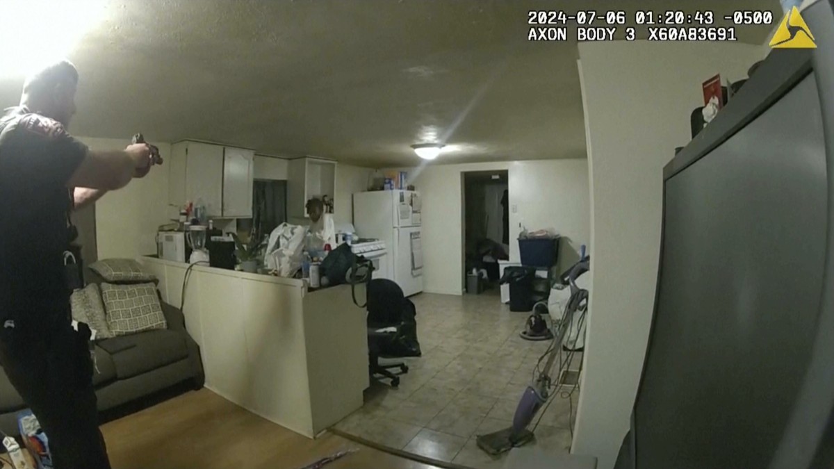 In this image taken from body camera video released by Illinois State Police on Monday, July 22, 2024, former Sangamon County Sheriff?s Deputy Sean Grayson, left, points his gun at Sonya Massey, who c ...