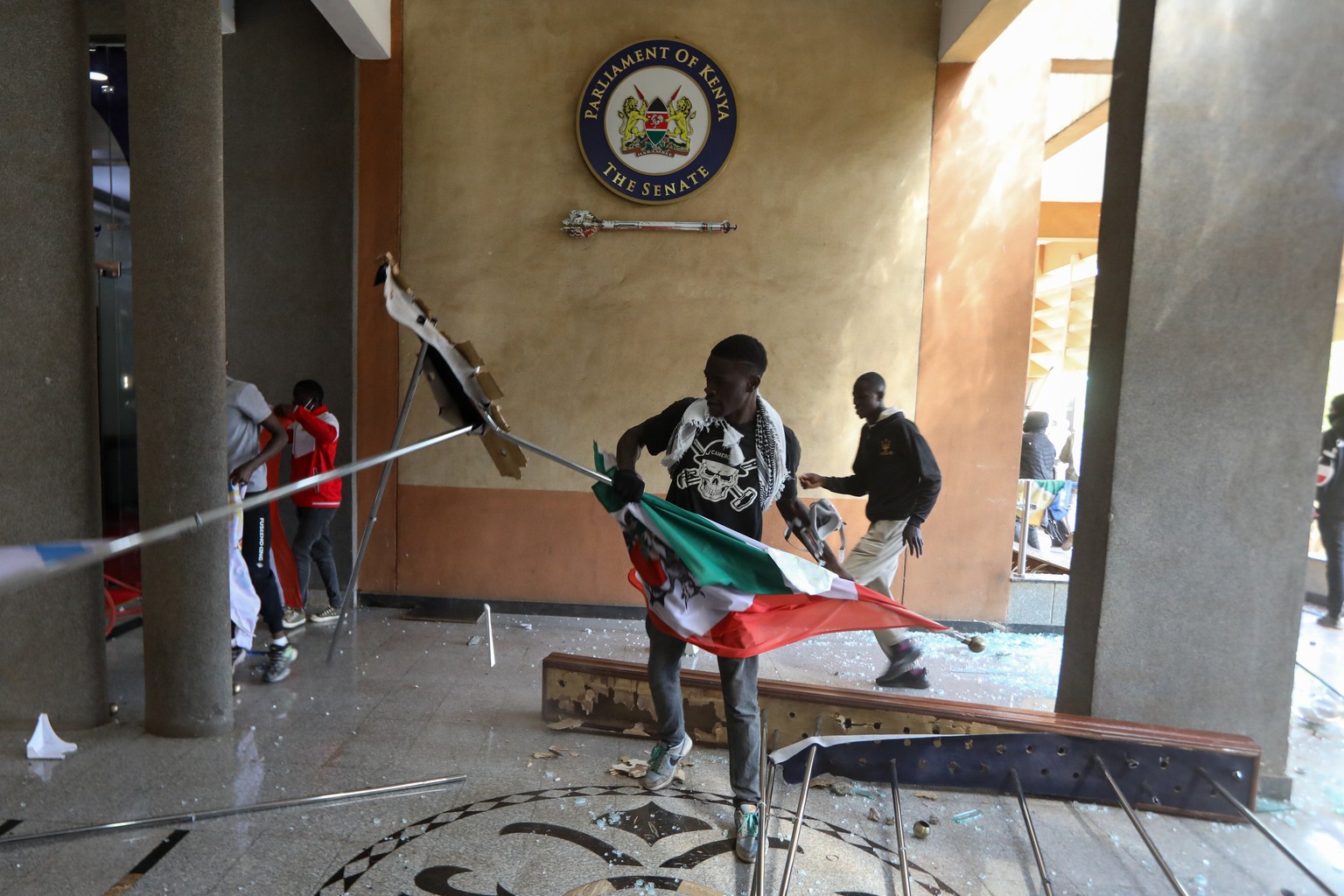epa11436376 Demonstrators breach into the Parliament building during a protest against a tax hikes in Nairobi, Kenya, 25 June 2024. Protesters have breached into the complex where parliament sits, set ...