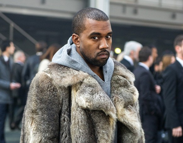 FILE - This Jan. 17, 2014 file photo shows singer Kanye West as he arrives for the Givenchy men&#039;s Fall-Winter 2014-2015 fashion collection in Paris. West will not face criminal charges over an in ...
